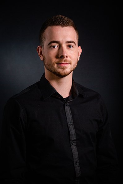 Kyliann LLITERAS smiling in a black shirt.